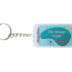 Lip balm keychain with teal and white design, silver chain, and Saucy Face text