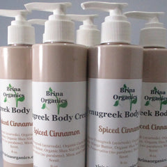 Body cream bottles with white pump tops, light brown color, and Brina Organics labels