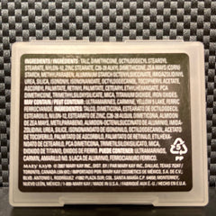 Close-up of matte lavender mineral eye shadow with smooth, velvety texture in compact pan