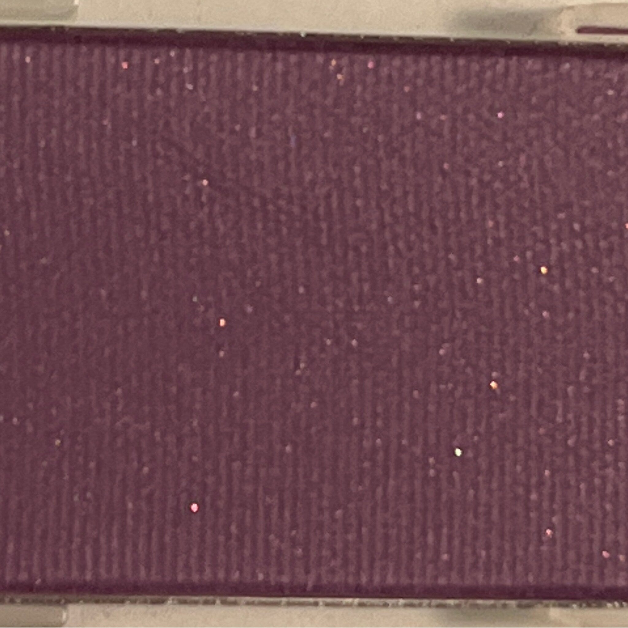 Shimmering Iris Mineral Eye Shadow pot with metallic purple powder and satin finish, shown open with brush.