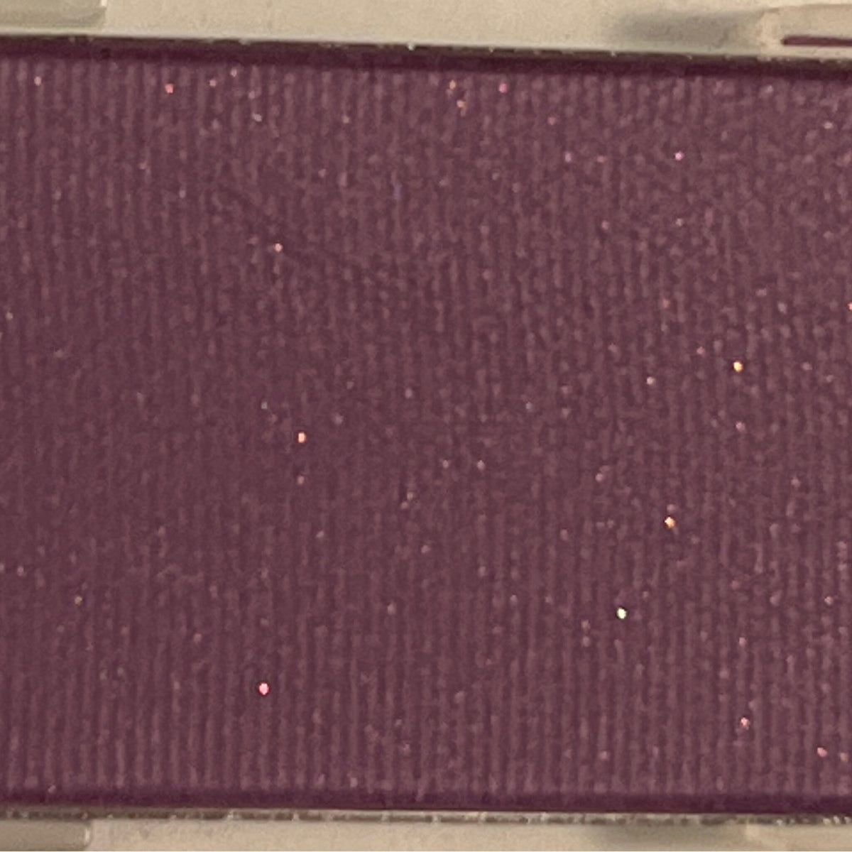 Shimmering Iris Mineral Eye Shadow pot with metallic purple powder and satin finish, shown open with brush.