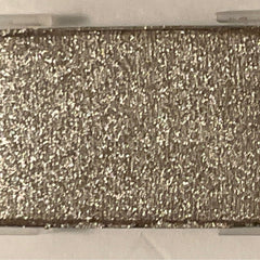 Close-up of shimmering mineral eye shadow in polished stone hue with metallic finish