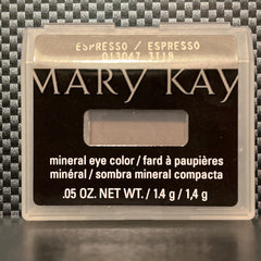 Side view of espresso brown mineral eye shadow in compact with reflective surface and subtle shimmer particles