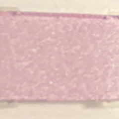 Close-up of shimmering dusty lilac mineral eye shadow in compact with reflective surface