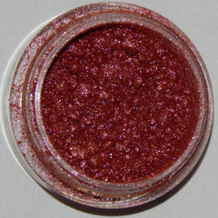 Close-up of Mineral Eyeshadow in Racy Lady showing rich plum shimmer and smooth pressed powder texture