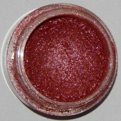 Close-up of Mineral Eyeshadow in Racy Lady showing vibrant pink shimmer powder in round compact case