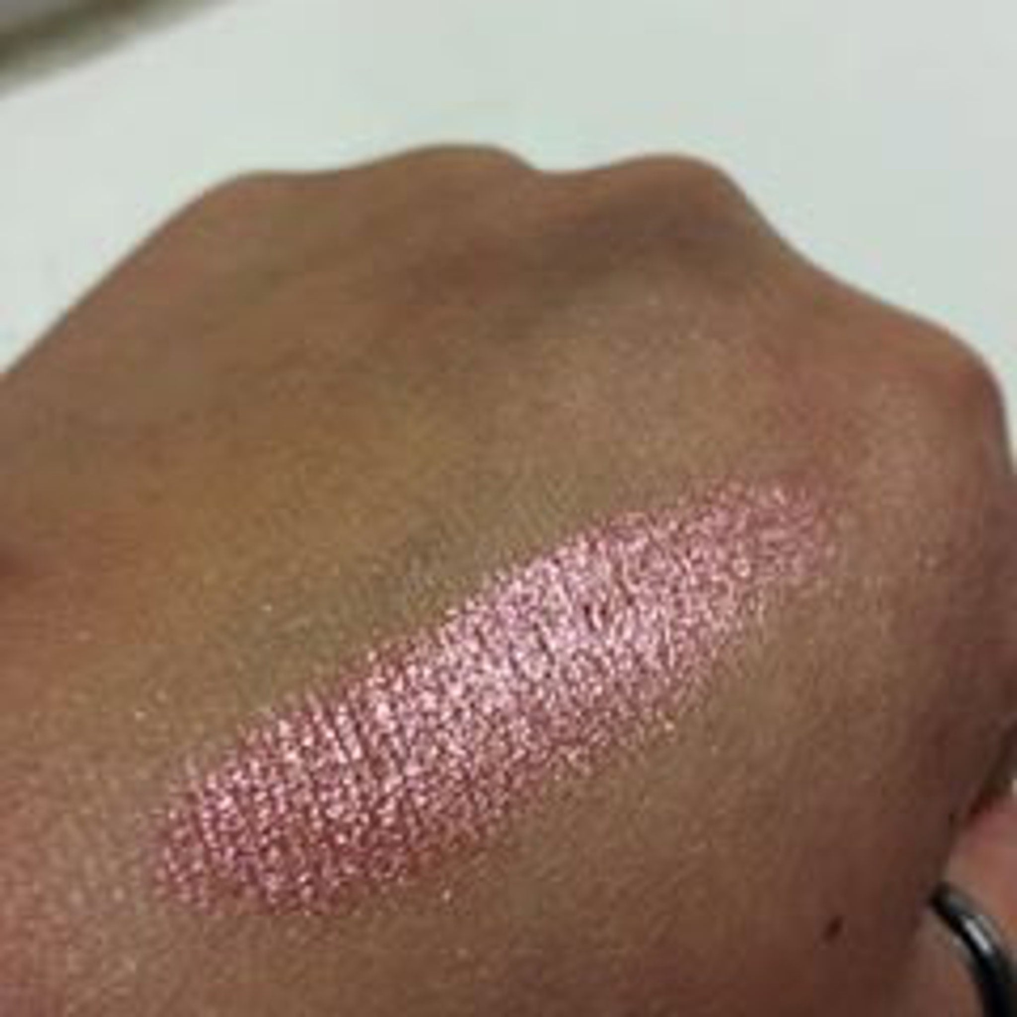 Side view of Mineral Eyeshadow in Racy Lady showing deep plum shade with satin finish in compact case