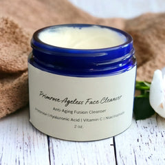 Face cleanser jar with blue rim, white label, and cream contents, Primrose Ageless Face Cleanser text visible