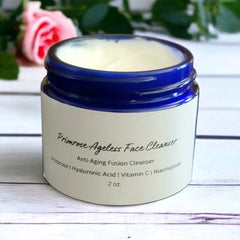 Face cleanser jar with blue rim, white label, and creamy contents, Primrose Ageless Face Cleanser visible