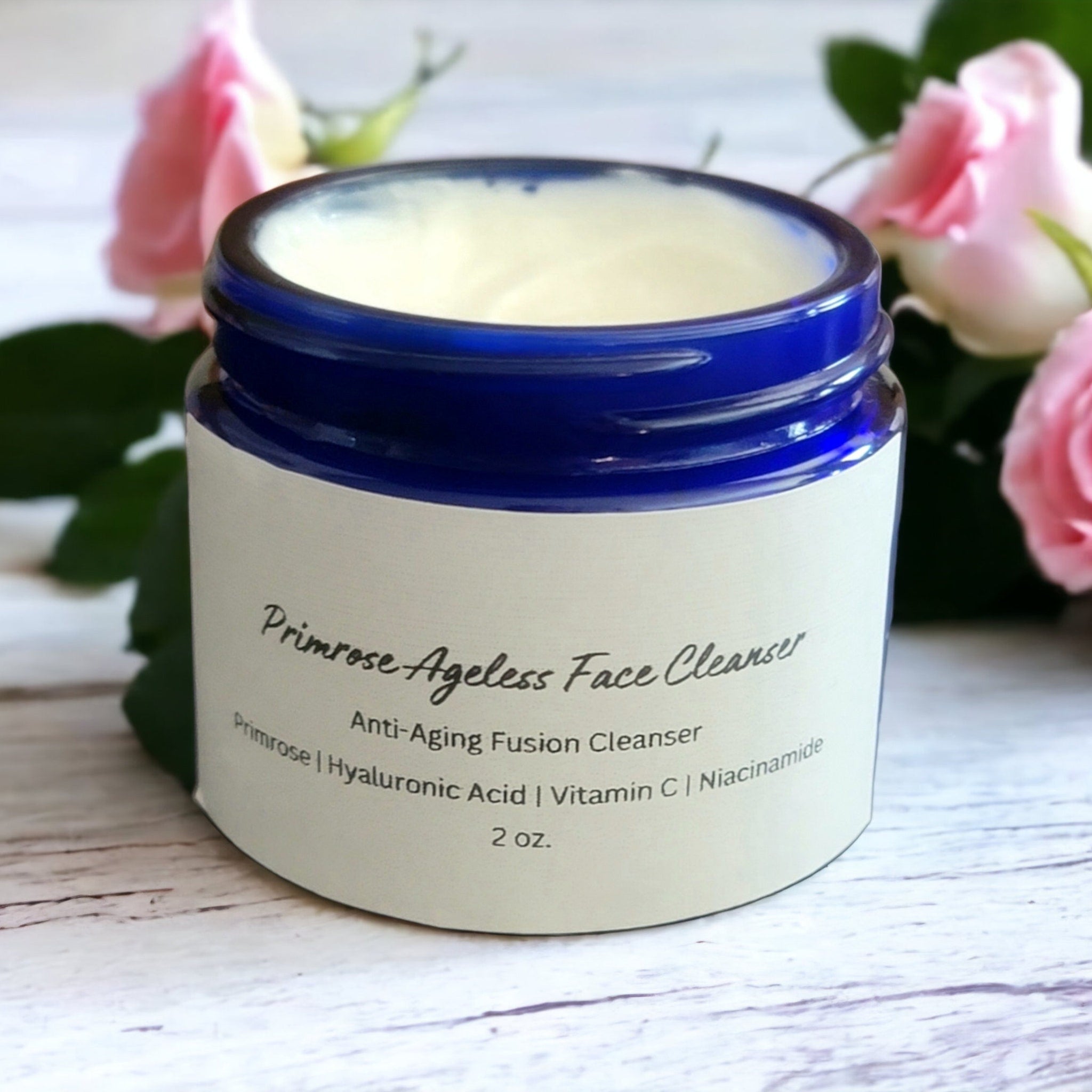 Face cleanser jar with blue rim, white label, and creamy contents, Primrose Ageless Face Cleanser text visible