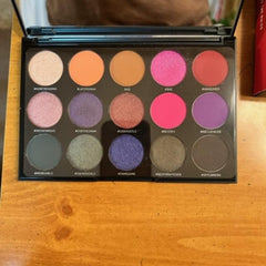 Side view of Morphe Social Butterfly palette showing 15 vibrant powder shadows in warm neutrals and bold jewel tones