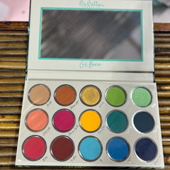 Eye shadow palette with multiple colorful eyeshadows in round pans, BeBella Cosmetics brand name visible