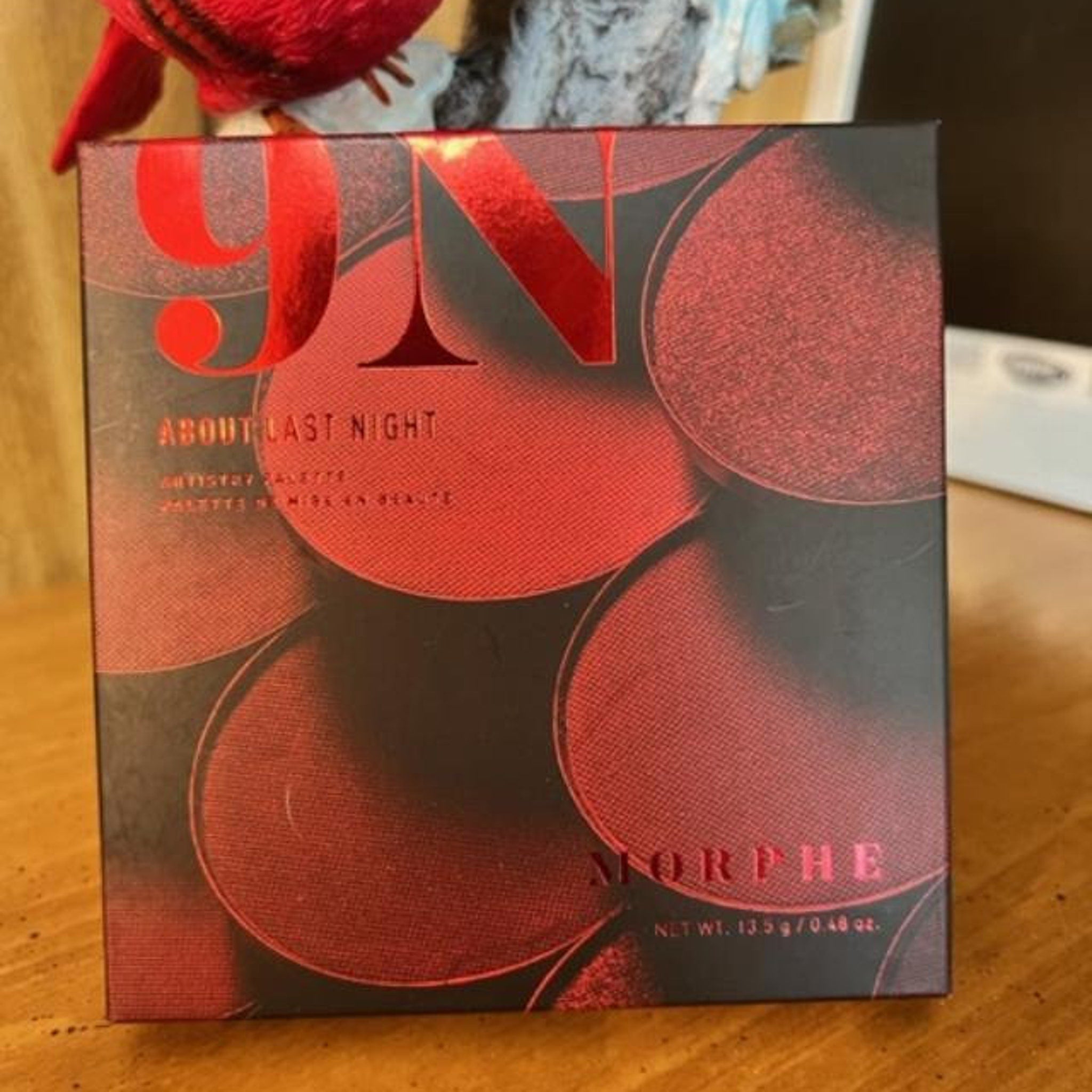Eye makeup palette with red and black color scheme, Morphe brand name visible on the box.