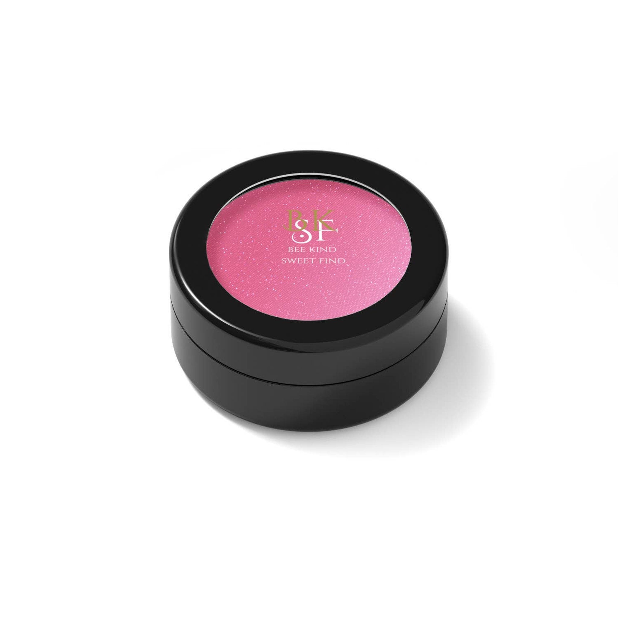 Blush compact with pink powder, black container, and brand text