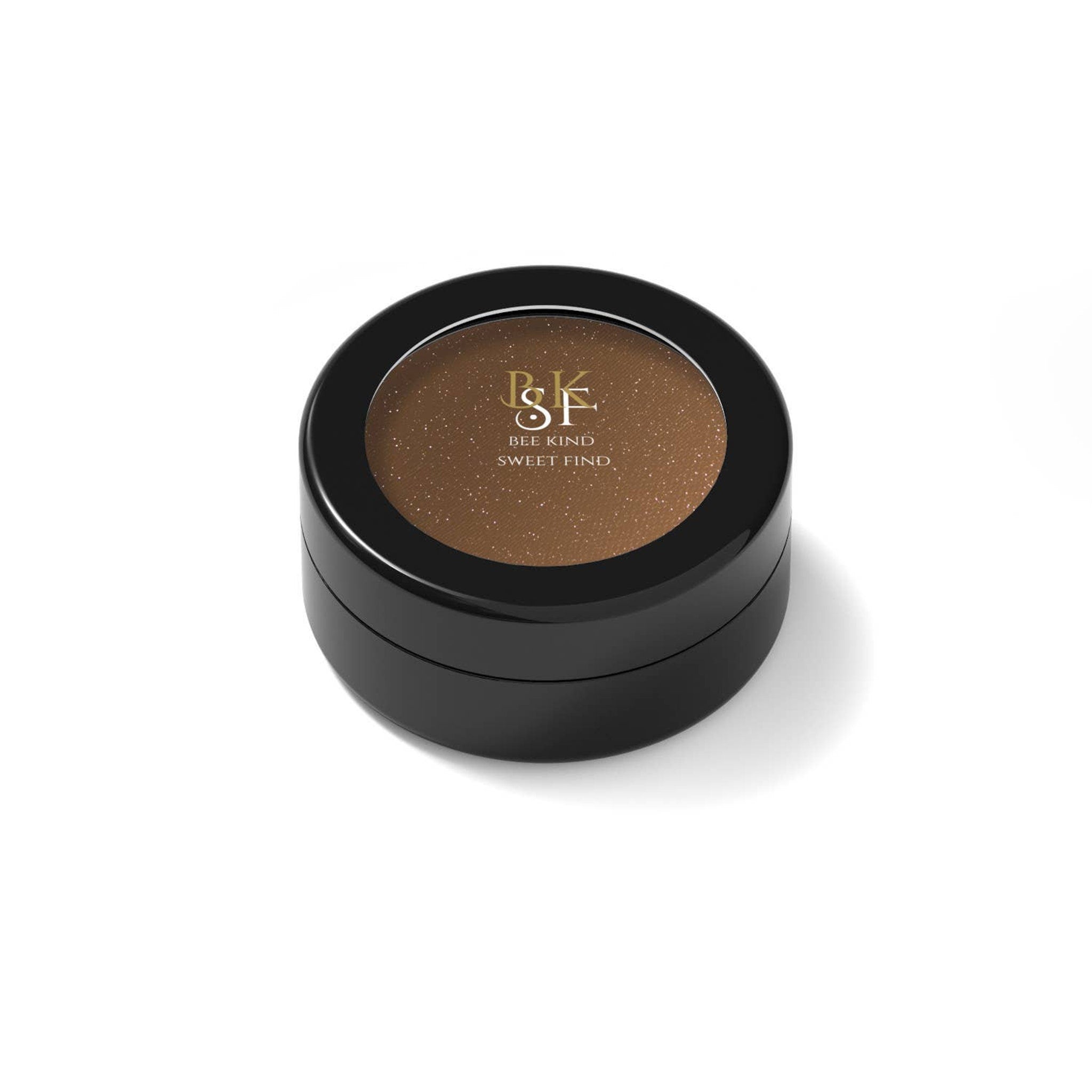 Brown eyeshadow compact with black case, gold text, and glittery finish