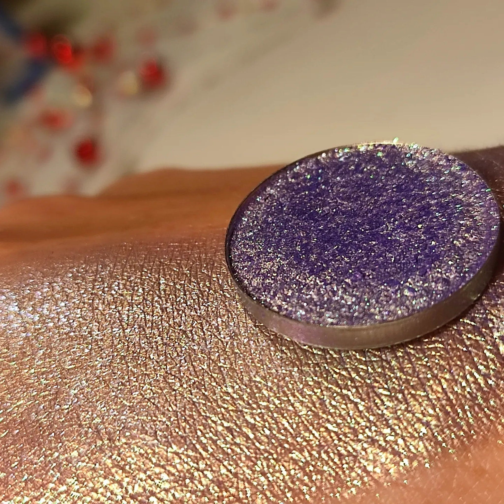 Side view of Blu Viola pressed powder eye shadow in deep violet shade with satin finish, showing compact angle.
