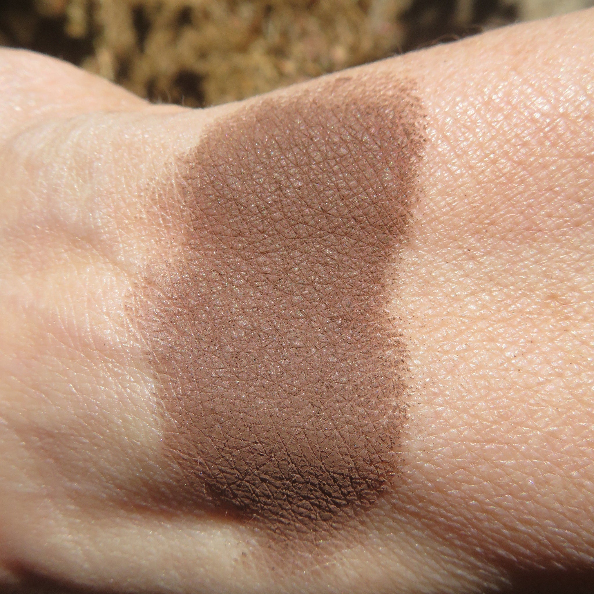 Dark matte brown loose mineral eyeshadow in vegan, cruelty-free powder form with smooth texture and minimalist packaging