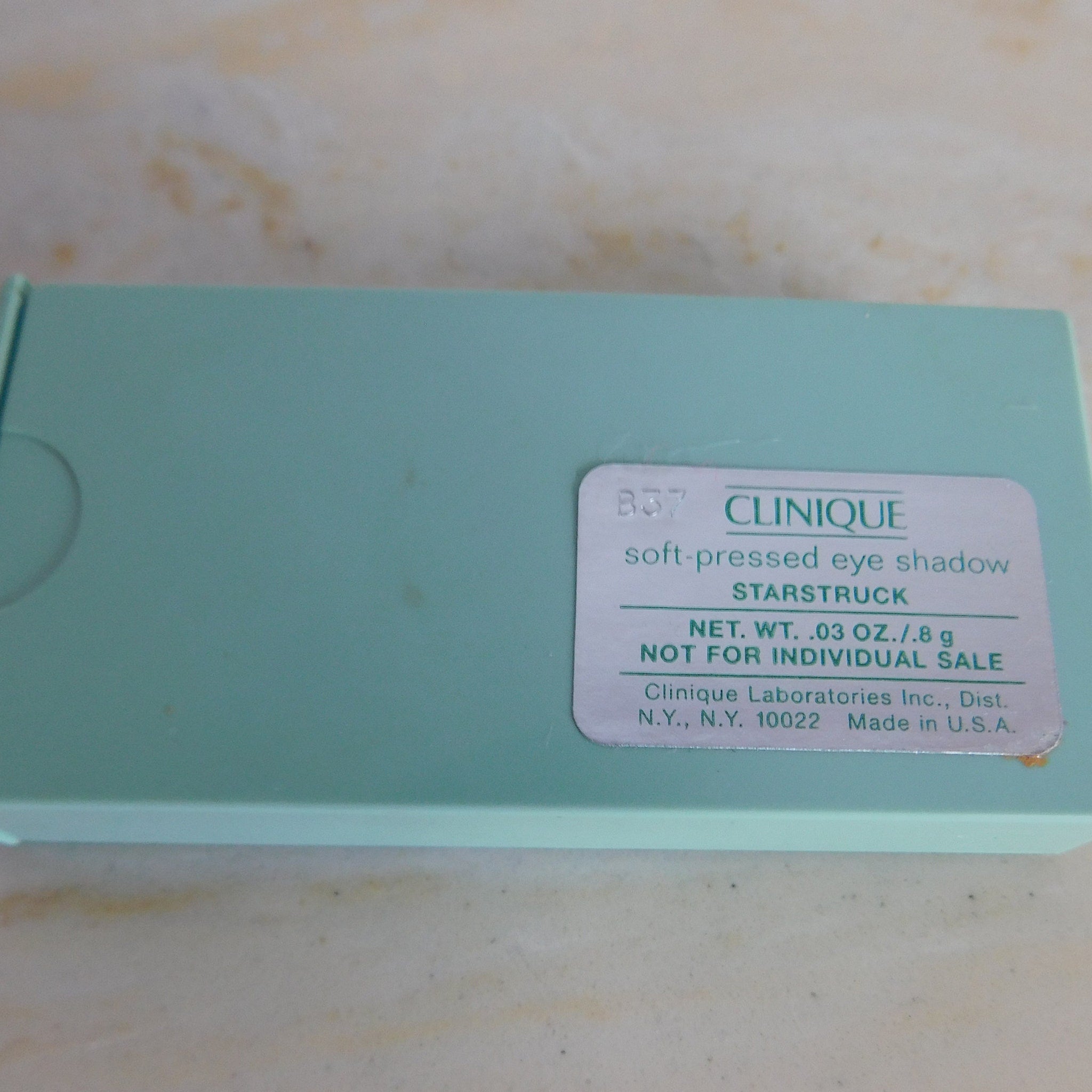 Soft-pressed eye shadow in mint green case with Clinique label, for individual sale