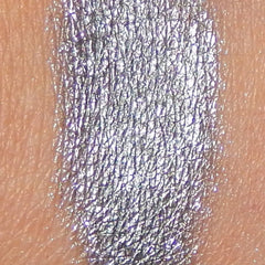 Side view of Arc Angel Mineral Eye Shadow pot showcasing its iridescent blue-purple pigment and compact round case