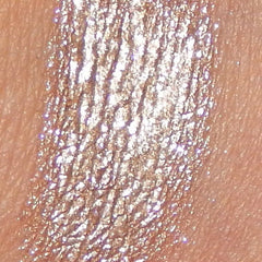 Side view of frothy mineral eyeshadow pot showing soft pink powder texture and compact size