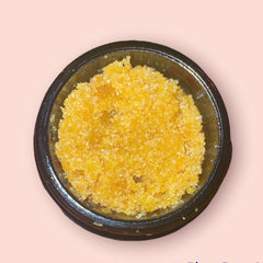 Concentrate in a dark glass container, with yellow and white crystals, on a pink background.
