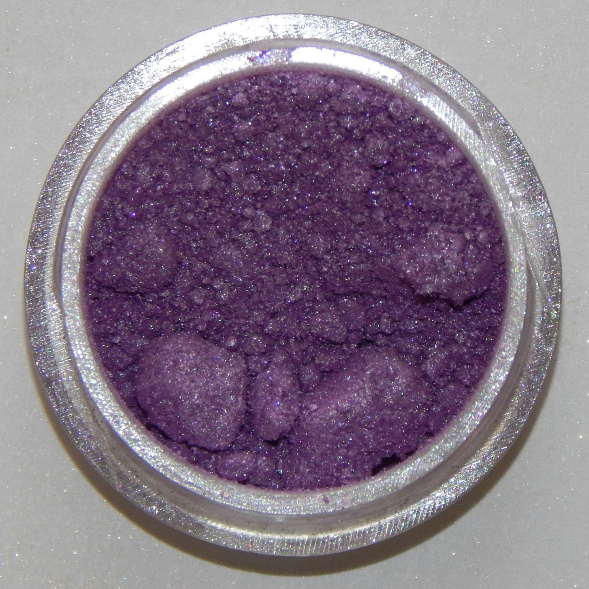 Close-up of soft lavender mineral eyeshadow with subtle shimmer in compact case