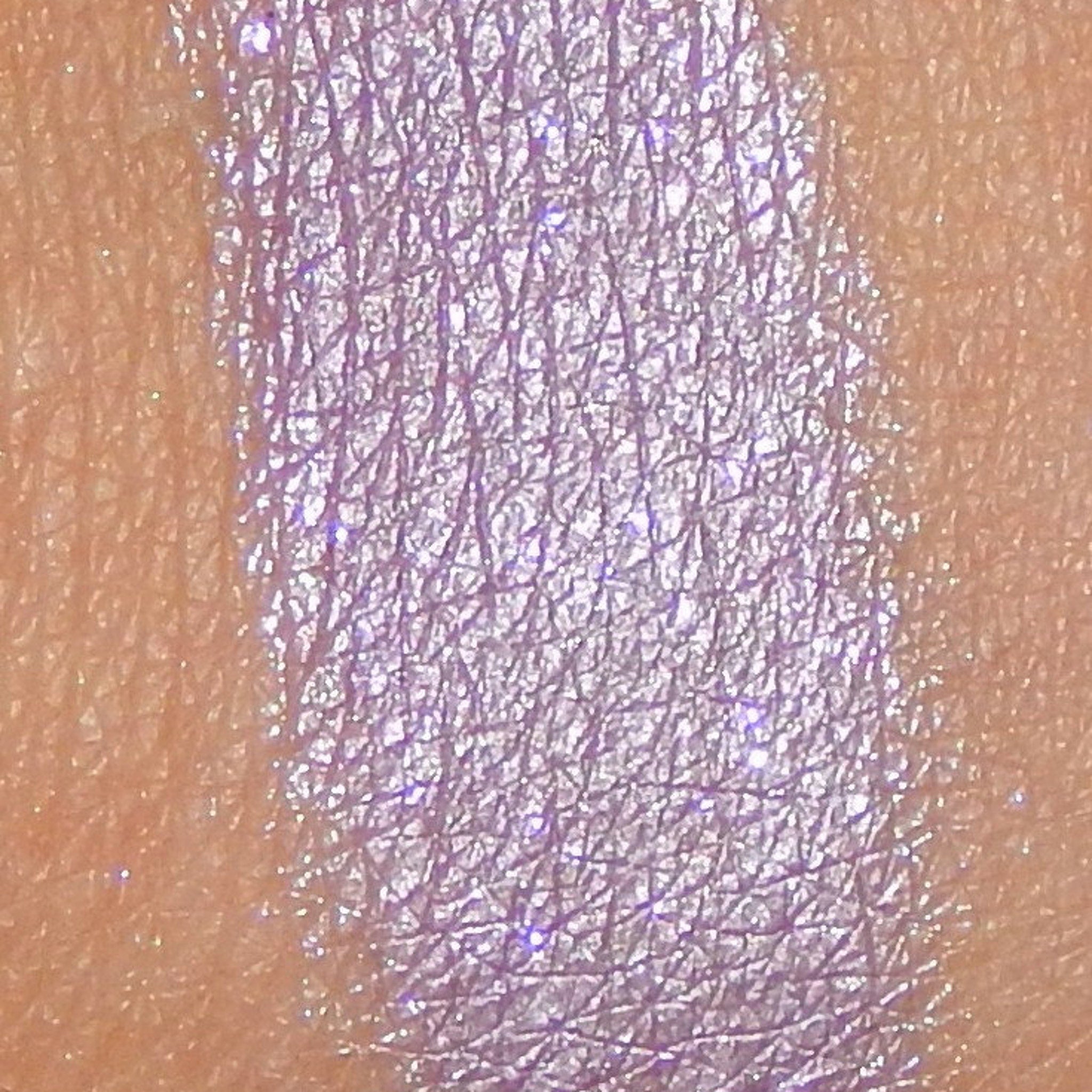 Side view of lavender mineral eyeshadow pot showing pressed powder texture and satin finish