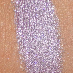 Side view of lavender mineral eyeshadow pot showing pressed powder texture and satin finish
