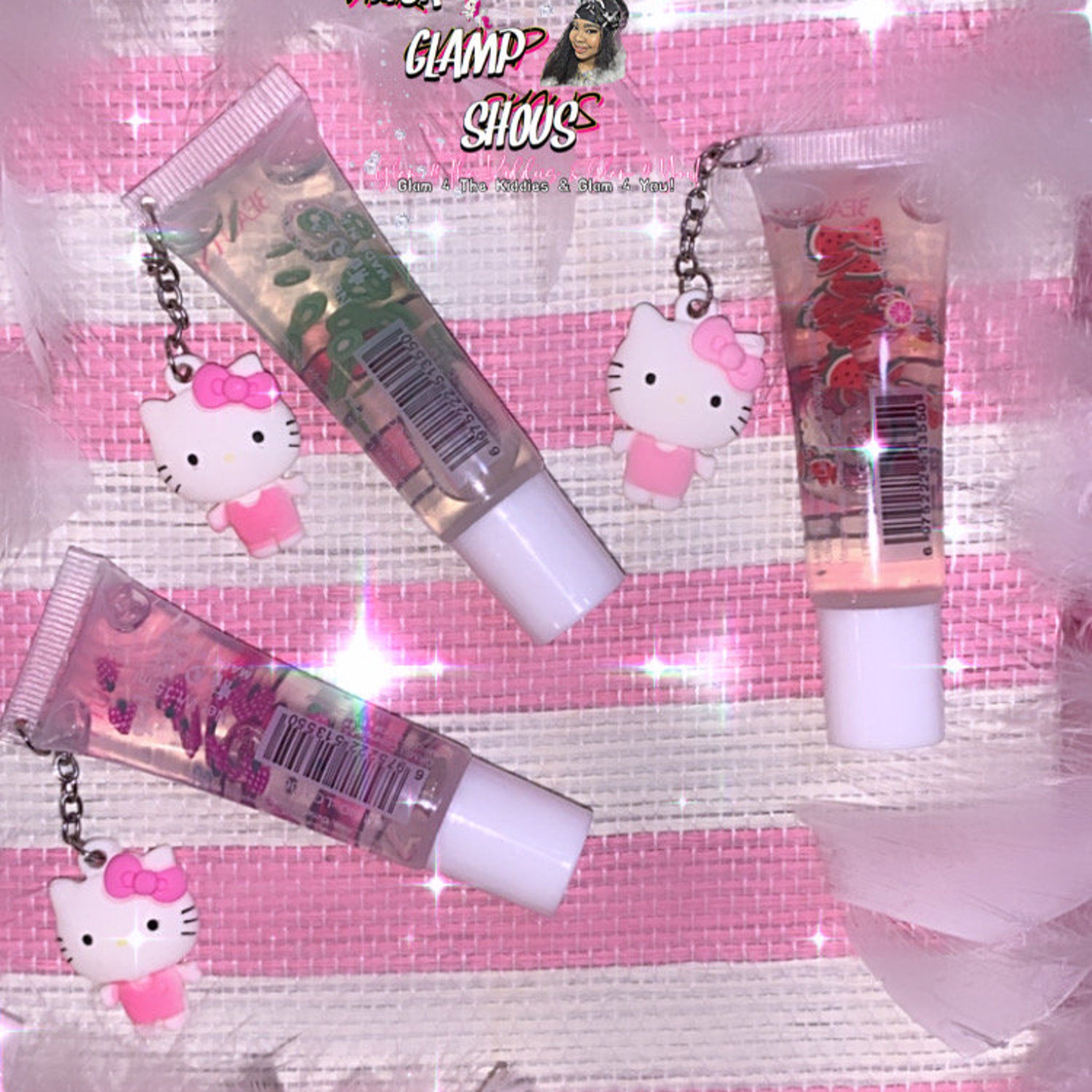 Lip gloss tubes with Hello Kitty charms, clear liquid, pink accents, and white caps