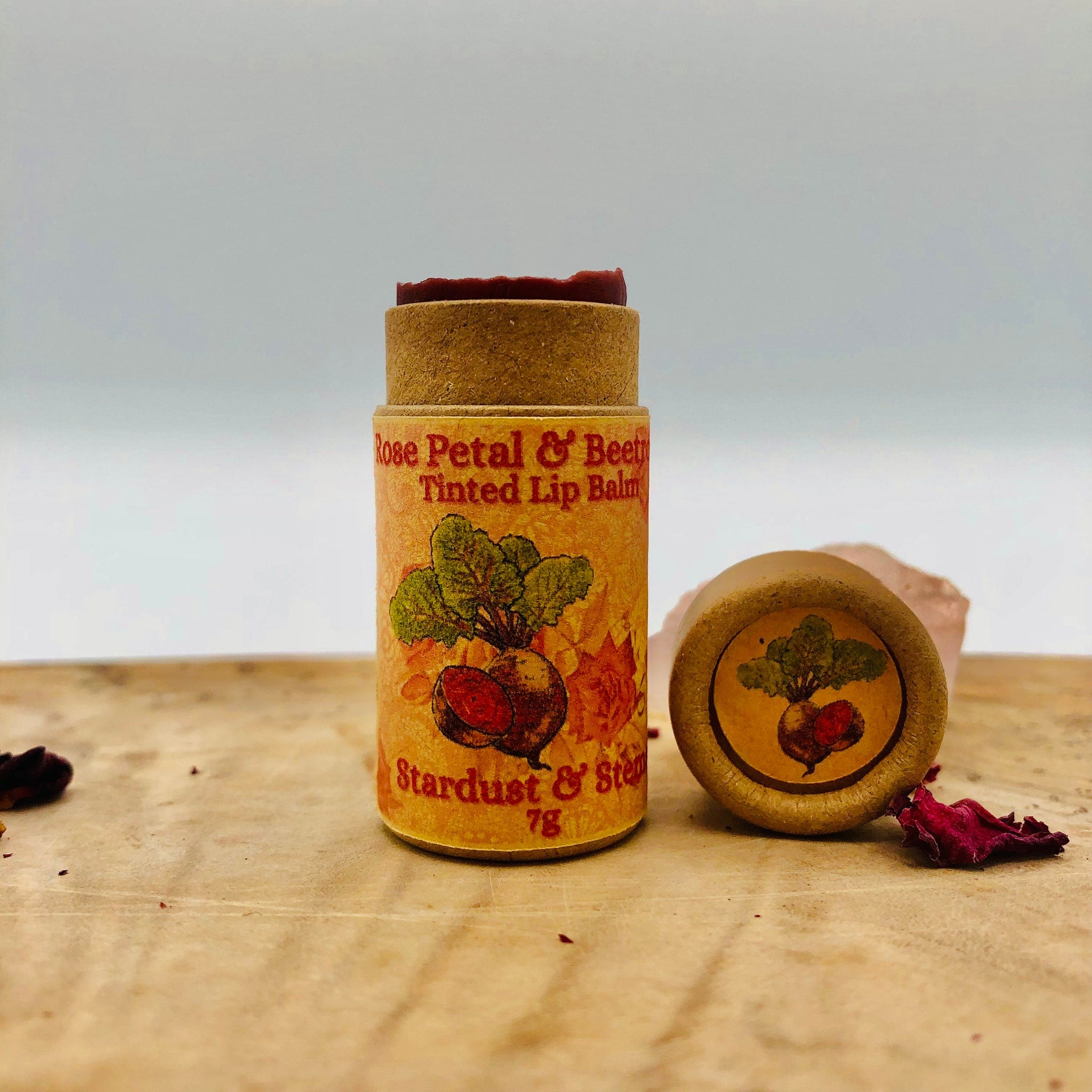 Tinted lip balm in brown cardboard tube with red balm, "Rose Petal & Beet" label, and beet illustration