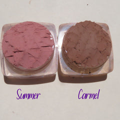 Close-up of four loose mineral eyeshadows in matte taupe, shimmer champagne, satin mauve, and metallic bronze shades