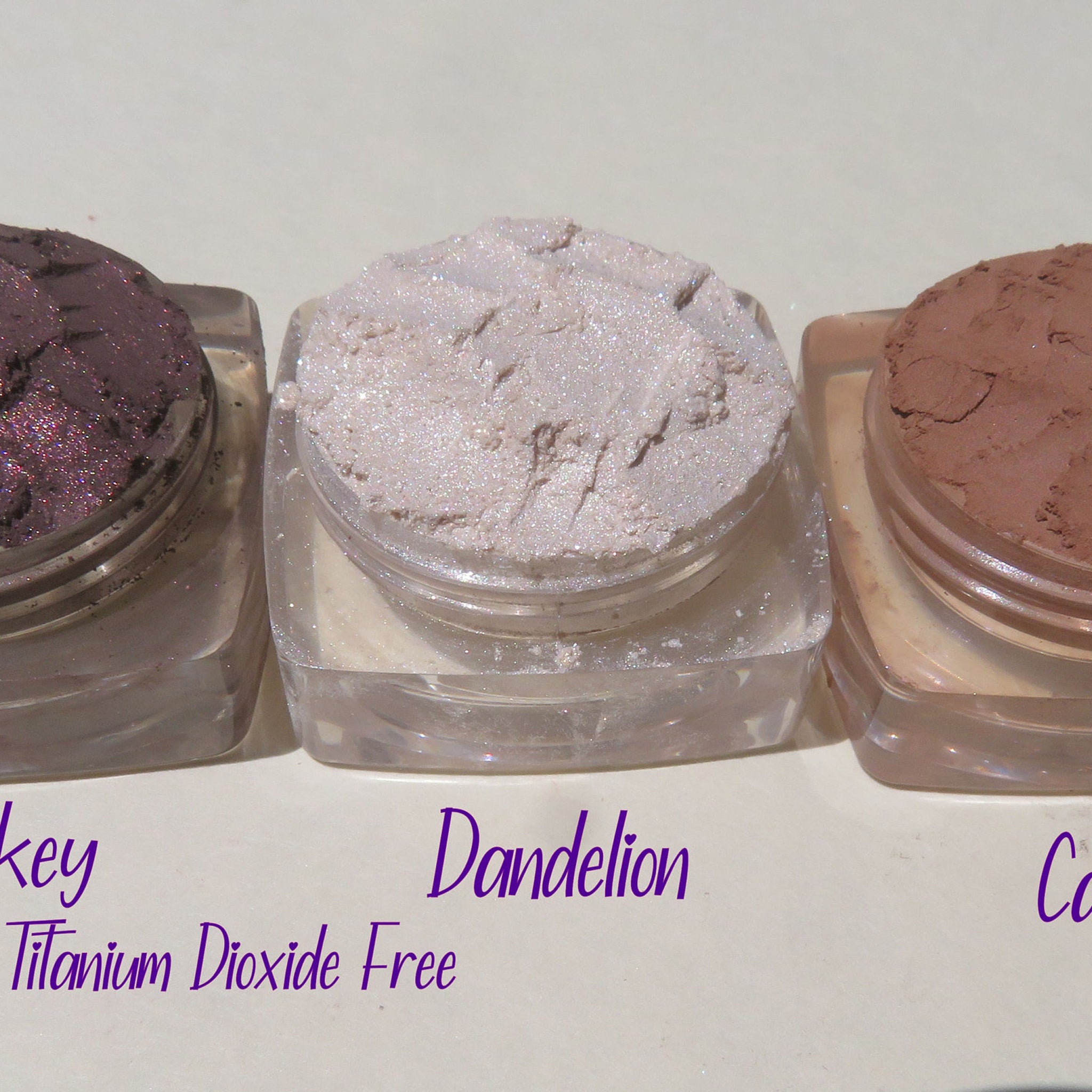 Square black compact with four vegan mineral eyeshadows in matte and shimmer shades, cruelty-free label visible