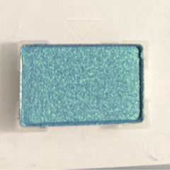 Mineral eye shadow compact in vibrant azure blue with smooth matte finish and circular pan
