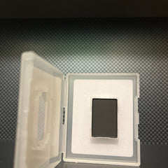 Side view of mineral coal eye shadow compact showing matte black case and deep charcoal powder texture