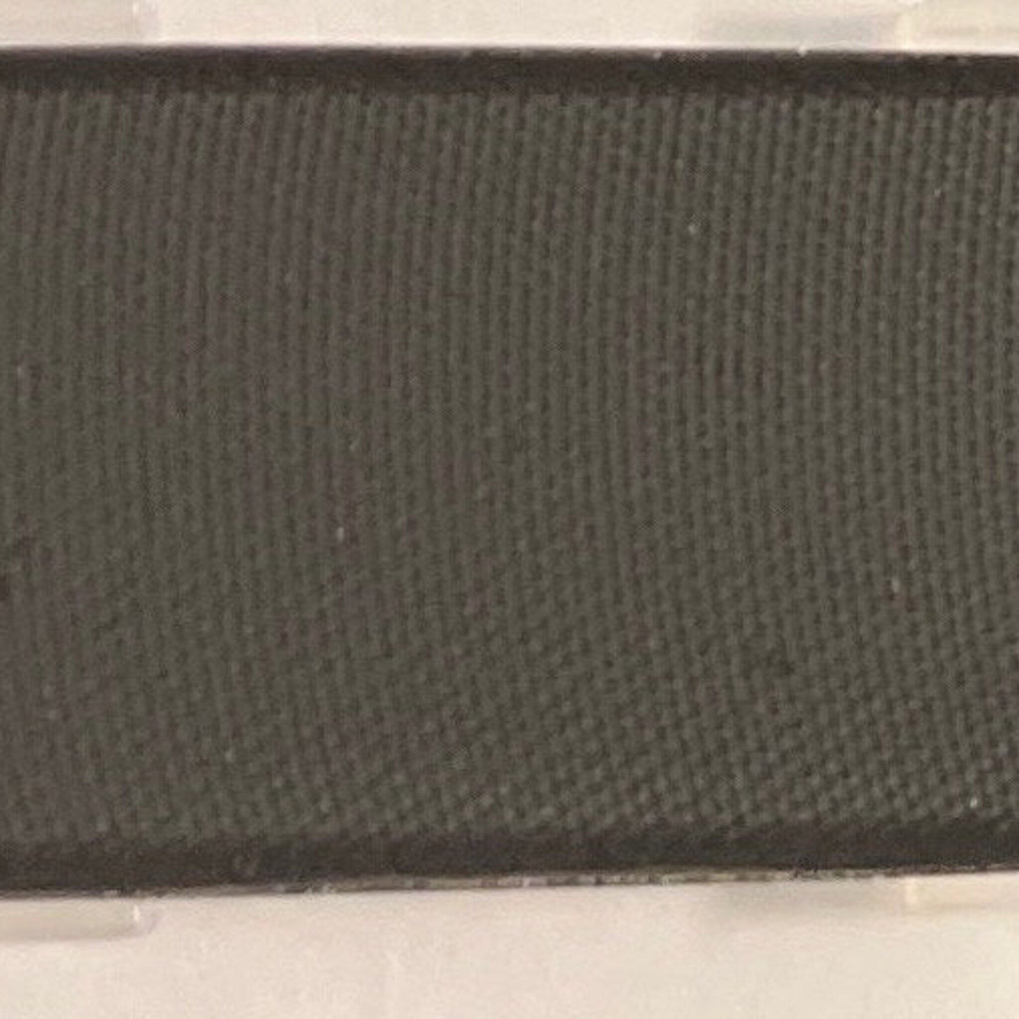 Close-up of matte black mineral coal eye shadow in compact case with sleek silver detailing