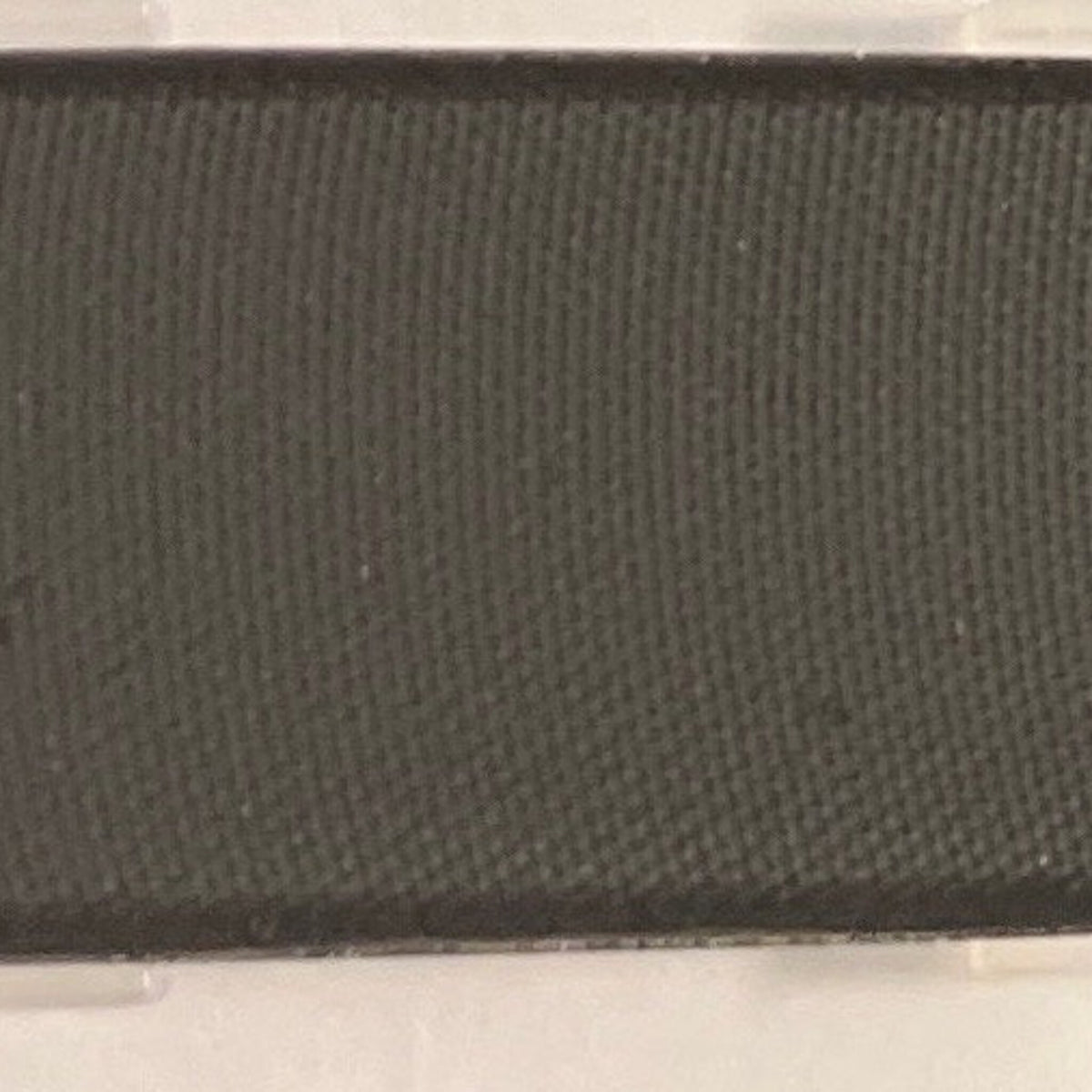 Close-up of matte black mineral coal eye shadow in compact case with sleek silver detailing