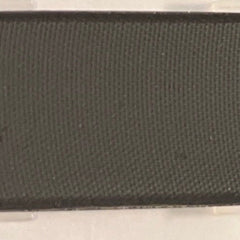 Close-up of matte black mineral coal eye shadow in compact case with sleek silver detailing