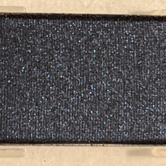 Close-up of Mineral Eye Shadow in Starry Night showing deep navy blue powder with shimmering silver flecks in compact case