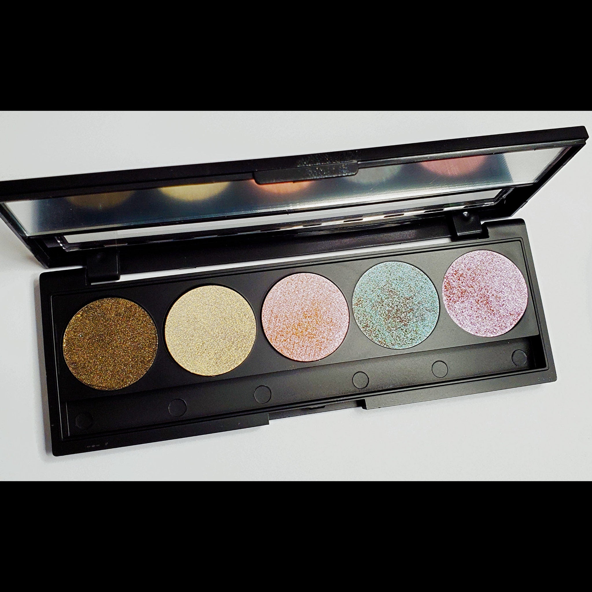 Side view of customizable 5-pan eyeshadow palette showing square pans with assorted matte and shimmer shades