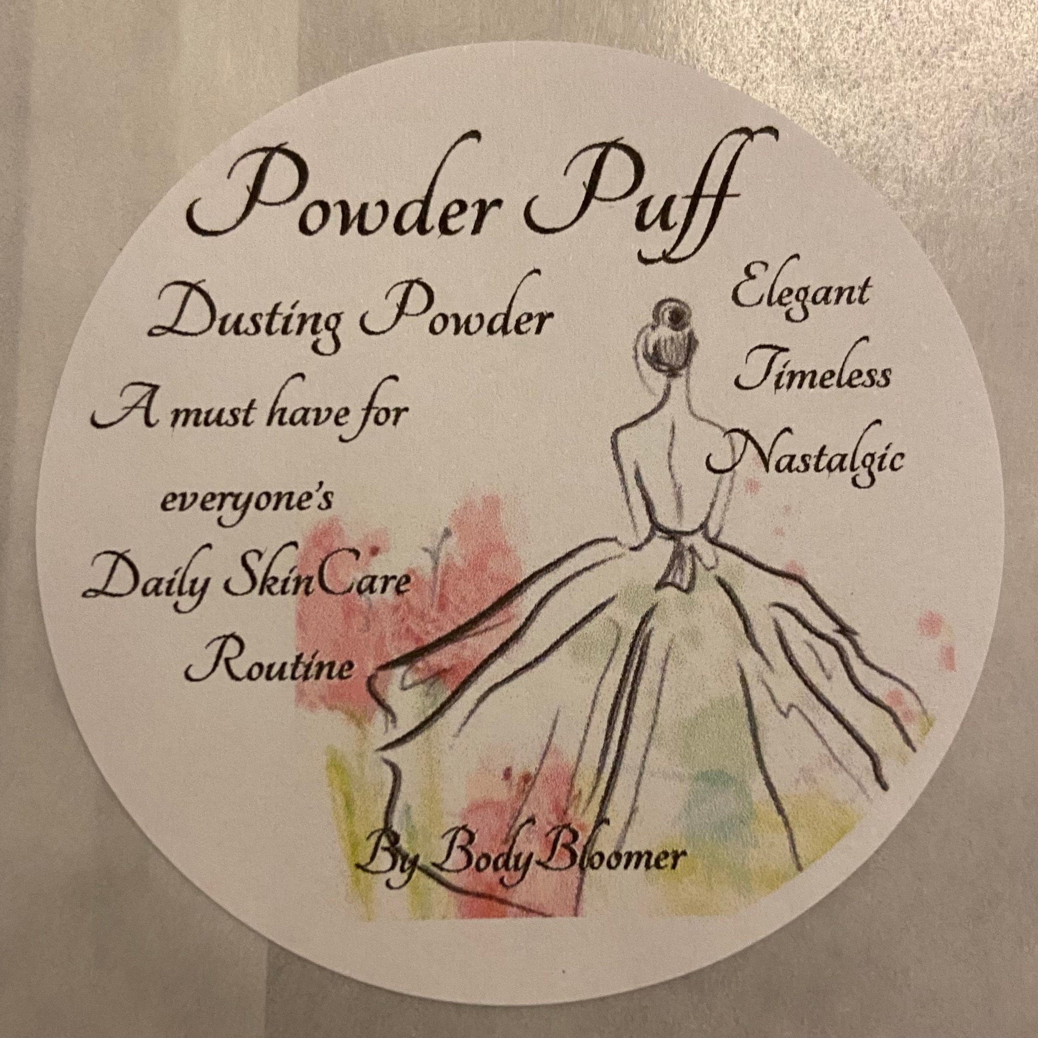 Powder Puff label with script text, illustration, and brand name By Body Bloomer on white background