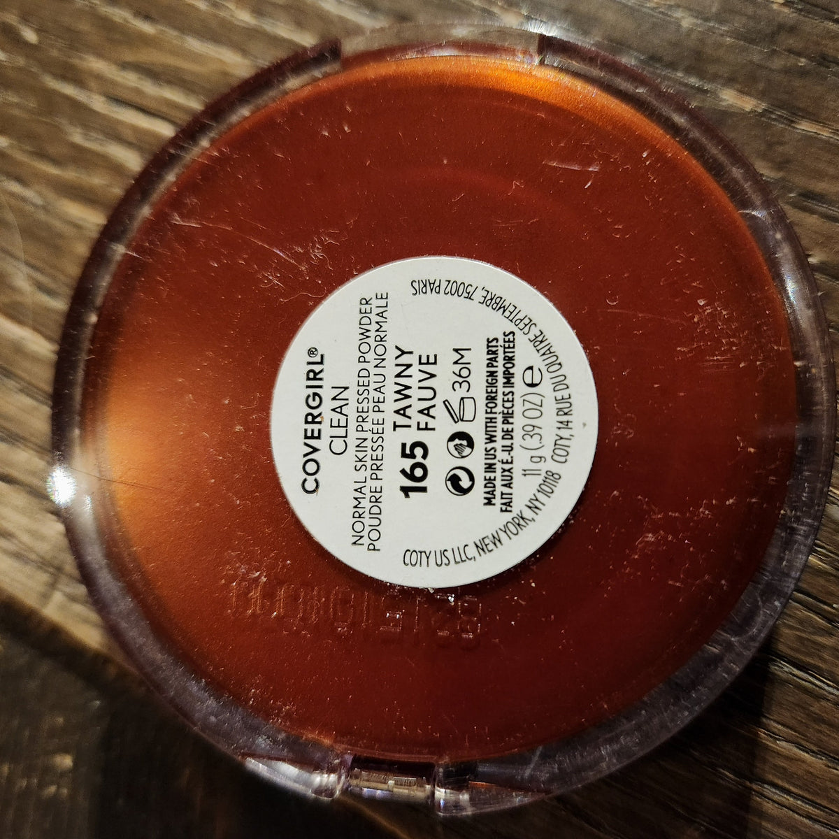Close-up of Covergirl powder eye shadow compact with mirrored lid and gradient bronze shades