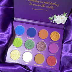 Midnight Garden Eyeshadow Palette featuring 12 vibrant shades in matte and shimmer finishes, housed in sleek black packaging