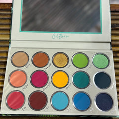 Eyeshadow palette with multiple colors, including gold, green, and blue, with "Cool Breeze" text on the lid.