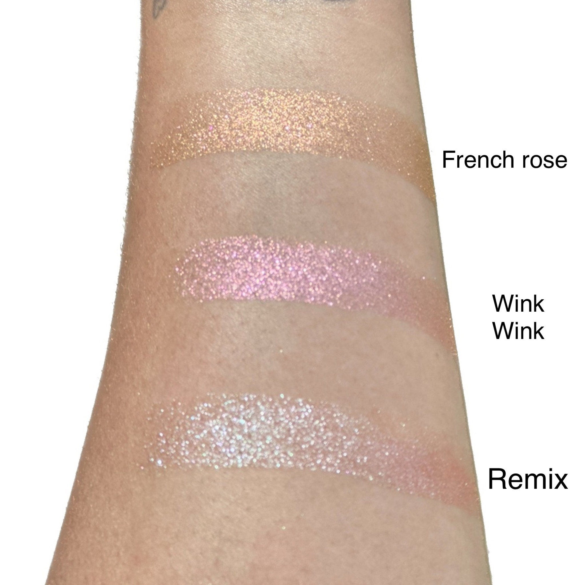 Two duo chrome eyeshadow pans showing color shift from bronze to green in minimalist packaging