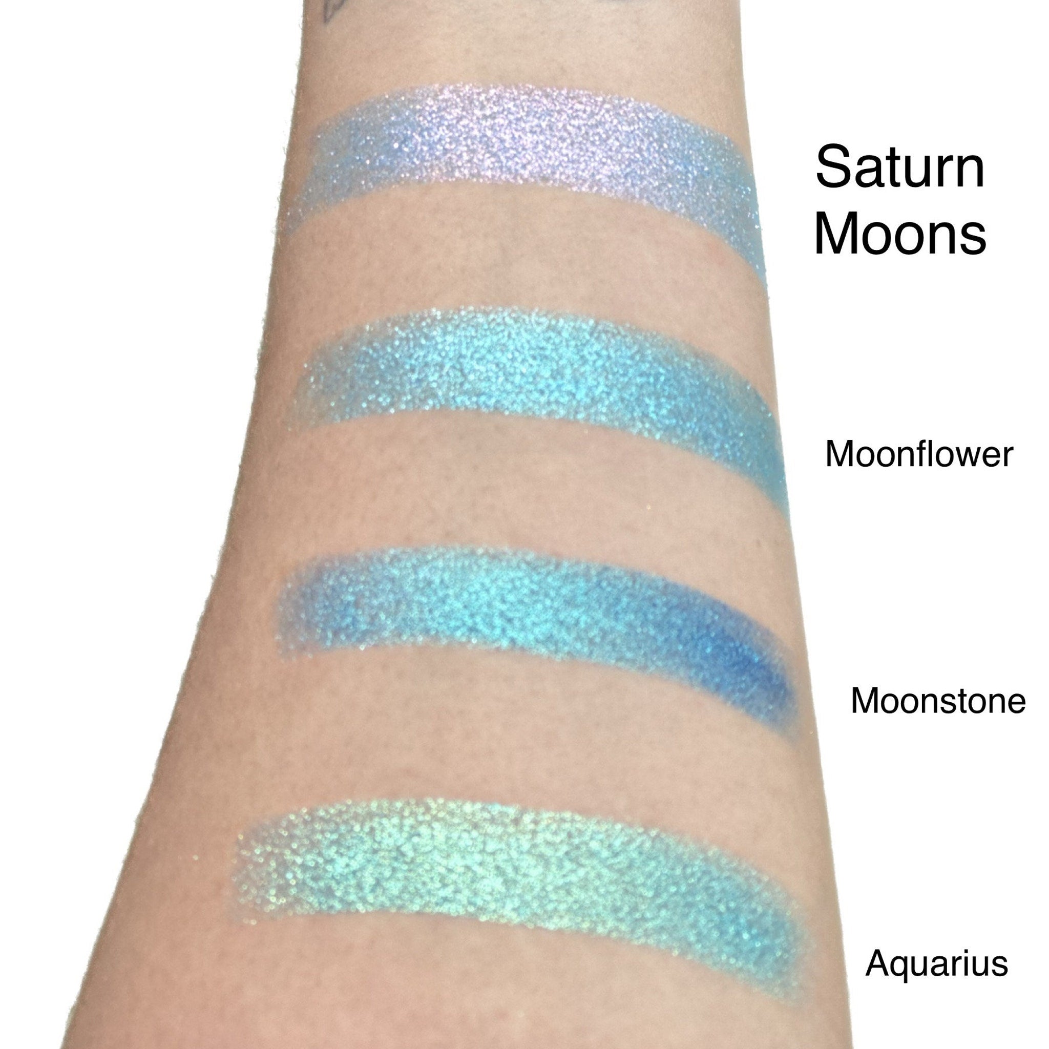 Close-up of duo chrome eyeshadow pan showing shifting iridescent hues under studio lighting