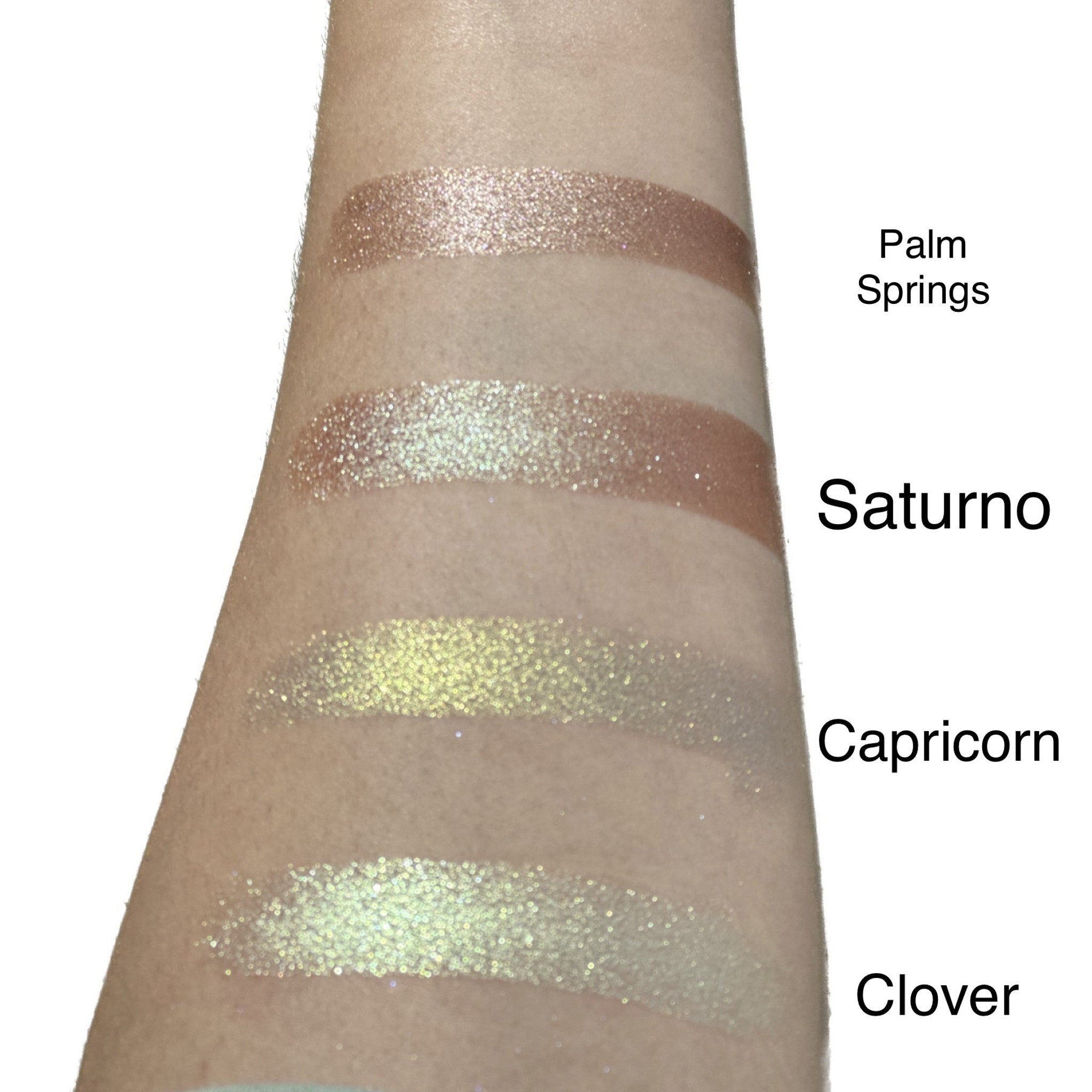 Side view of duo chrome eyeshadow single pan showing metallic color shift from bronze to green