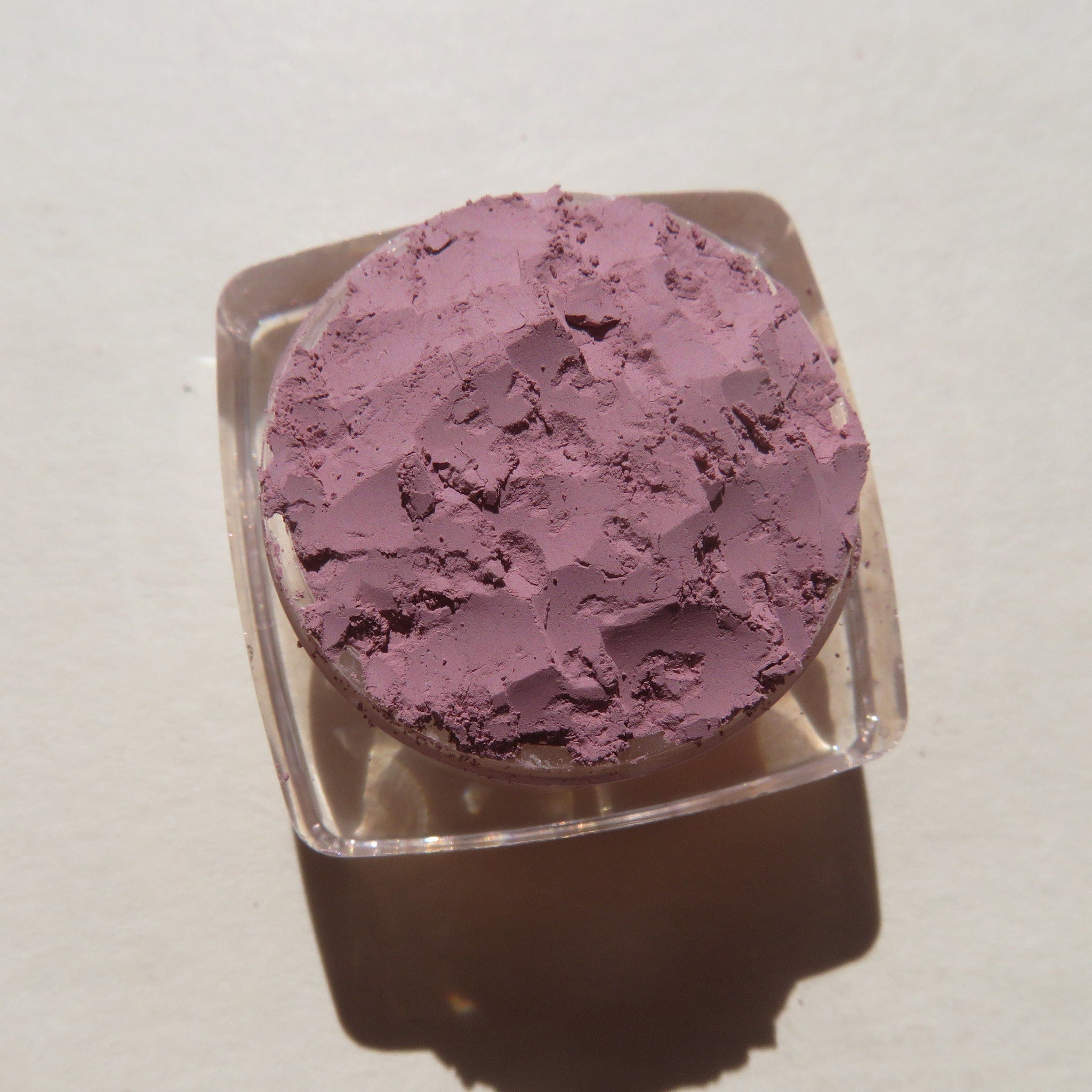 Close-up of matte light purple loose mineral eye shadow with soft powdery texture in Persian Lily shade
