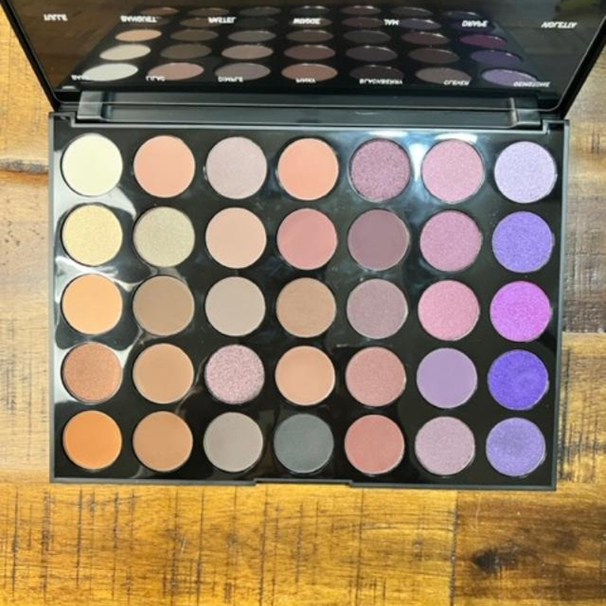 Side view of Morphe 35P Plum Pleasers palette showing 35 matte and shimmer purple-toned eye shadows in rectangular pans