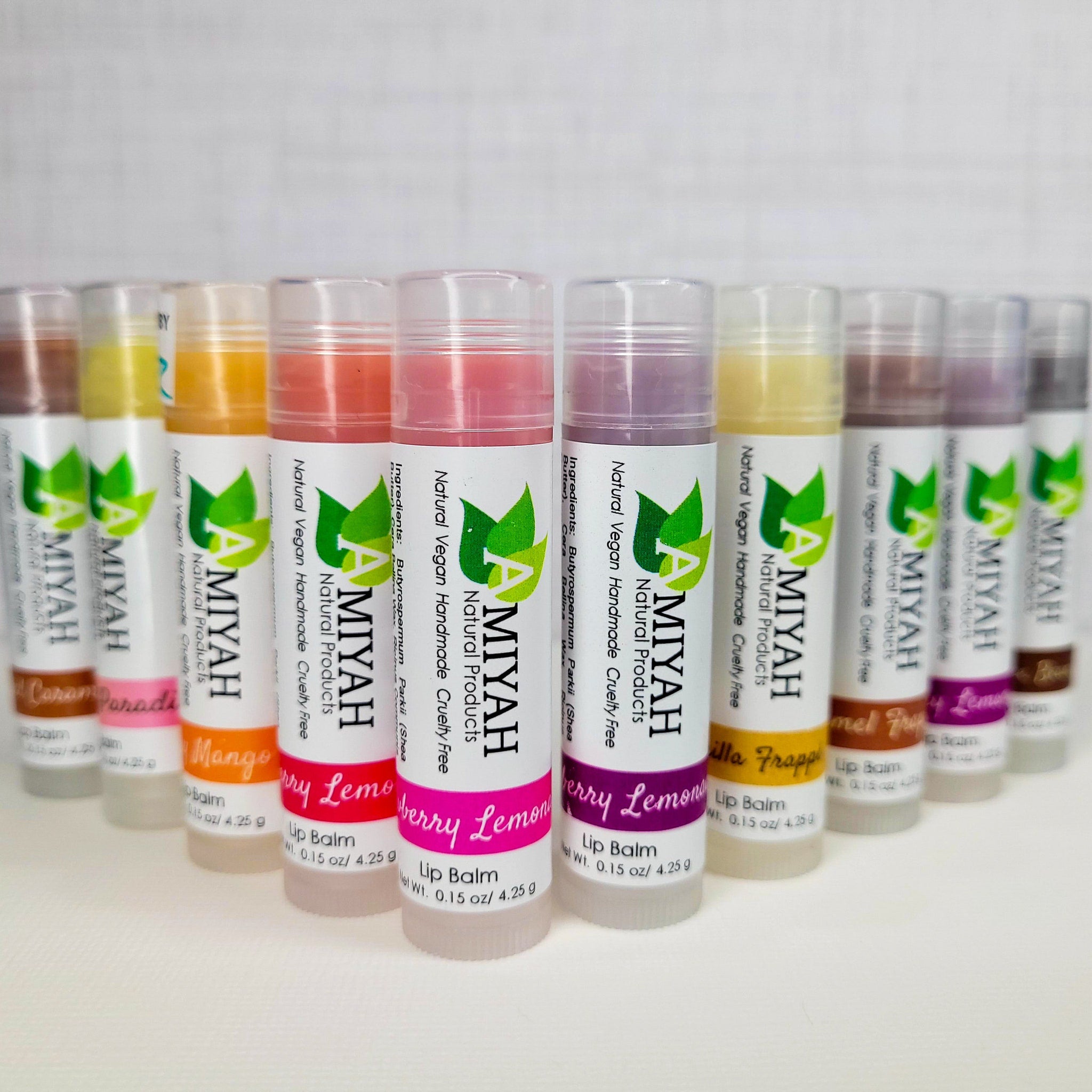 Lip balms with white and colorful labels, clear tubes, and Amiyah Natural Products branding displayed