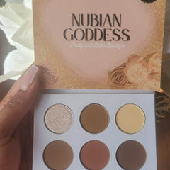 Open Nubian Goddess Eyeshadow Palette displaying 12 vibrant matte and shimmer shades in warm earthy tones